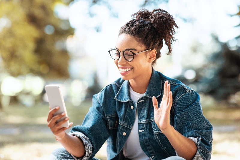 Happy woman using smartphone to make a video call